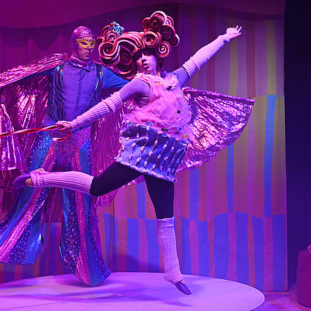 Zwei Personen tanzen auf dem Pult. 